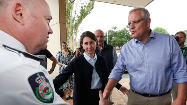 Prime Minister Scott Morrison and NSW Premier Gladys Berejiklian arrive at the Picton Bowling club that has been turned into a Evacuation Centre on Sunday.