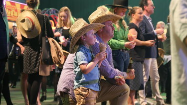 Dan O’Brien and Riley O’Brien, 4, watching the show of motorbike riders at the Ekka launch in 2019.