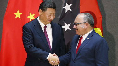 Papua New Guinea's Prime Minister Peter O'Neill shakes hands with Xi Jinping on Friday.