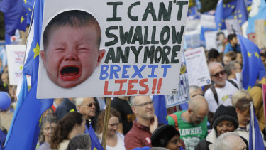 Anti-Brexit demonstrators carry placards and EU flags in London on Saturday.