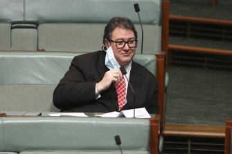 Nationals MP George Christensen removes his mask in Parliament to share his view that masks don’t work.