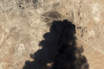 A satellite image shows thick black smoke rising from Saudi Aramco's Abqaiq oil processing facility.