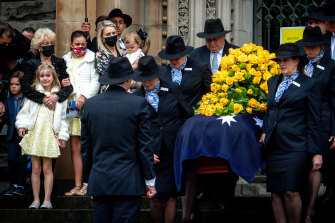 Bert Newton’s widow Patti and daughter Lauren look on as the TV icon’s casket leaves St Patrick’s Cathedral. 