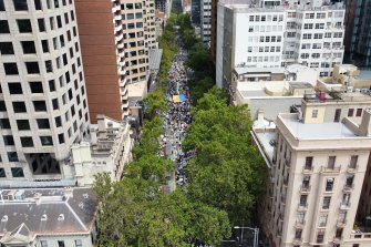 A crowd of about 3000 people march along Collins Street from Treasury Gardens.