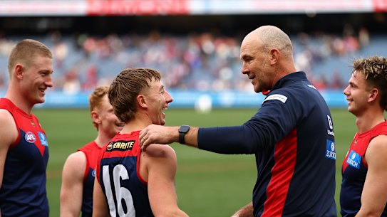 Bailey Laurie celebrates the Demons’ win with coach Steven King.