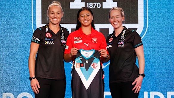Port Adelaide’s top draft pick Hannah Ewings poses with star recruit Erin Phillips (left) and new coach Lauren Arnell (right).