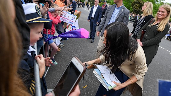 Gavin hands Meghan the pasta necklace.