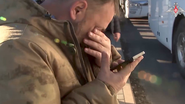 A Russian soldier reacts as he speaks on the phone with his relative after being released in a prisoners swap.