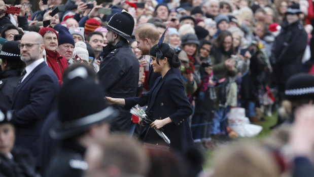 Prince Harry and Meghan, Duchess of Sussex meet members of the crowd after the Christmas Day service.