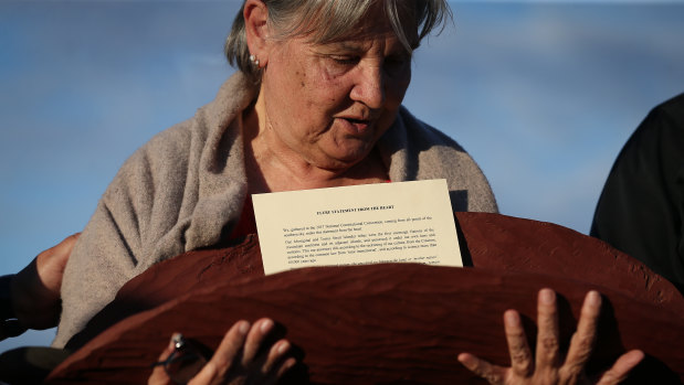 Pat Anderson from the Referendum Council with a piti holding the Uluru Statement from the Heart.