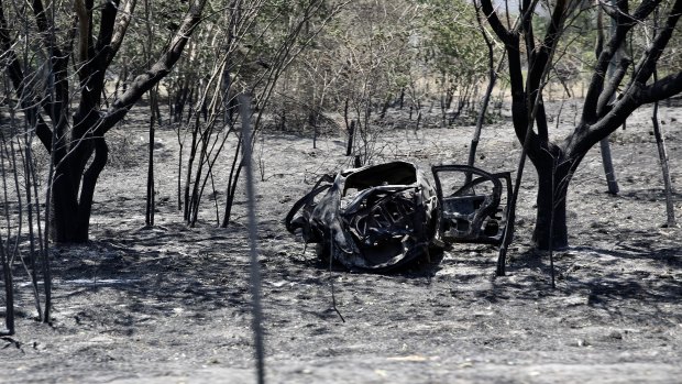 A burnt-out car in Kabra.
