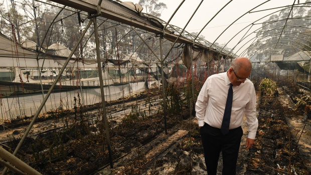 Prime Minister Scott Morrison tours a bushfire-damaged farm in Sarsfield.