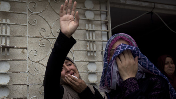 Relatives of 15-year-old Othman Hellis, mourn during his funeral in the family home in Gaza City, Saturday, July 14. Hellis was killed on Friday at a border protest.