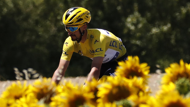 France's Julian Alaphilippe, wearing the Tour de France leader's yellow jersey, rides next to a field of sunflowers during the fourth stage last year.
