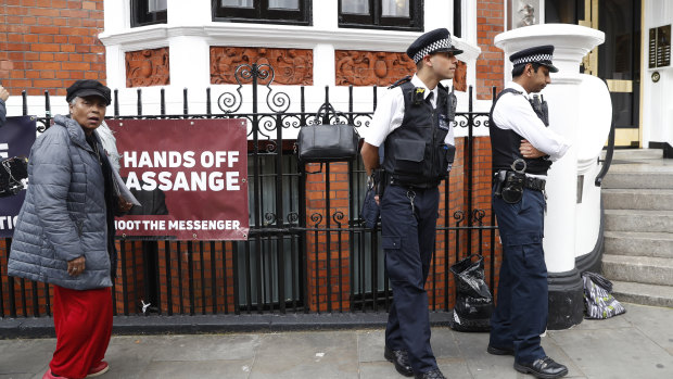 British police guard the Ecuadorian embassy as protesters supporting WikiLeaks founder Julian Assange hold a demonstration.