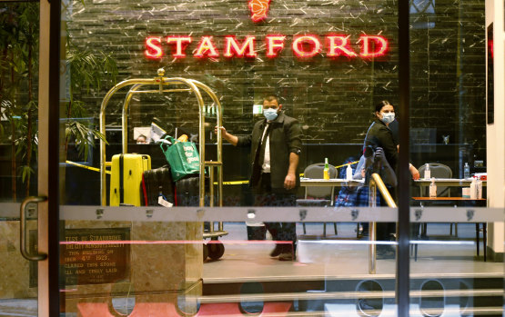 Staff at the Stamford Hotel in Melbourne move luggage for guests in quarantine in June.