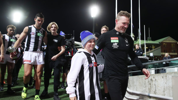 Nathan Buckley celebrates victory with son Ayce Buckley.