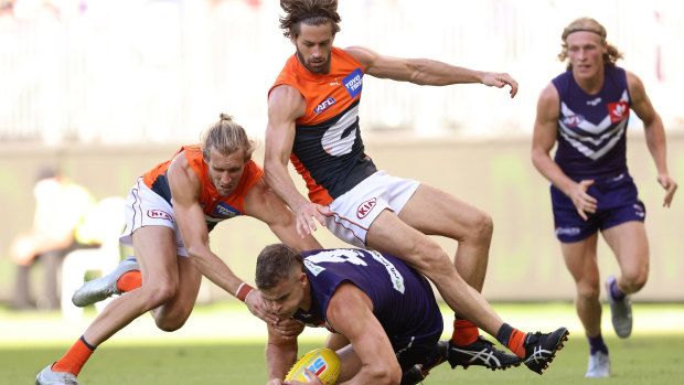 Sean Darcy of the Dockers contests for the ball against Nick Haynes and Callan Ward.