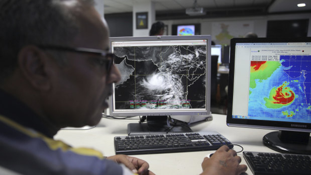 A staffer monitors cCyclone Vayu at the Indian Meteorological Department office in Delhi, India.