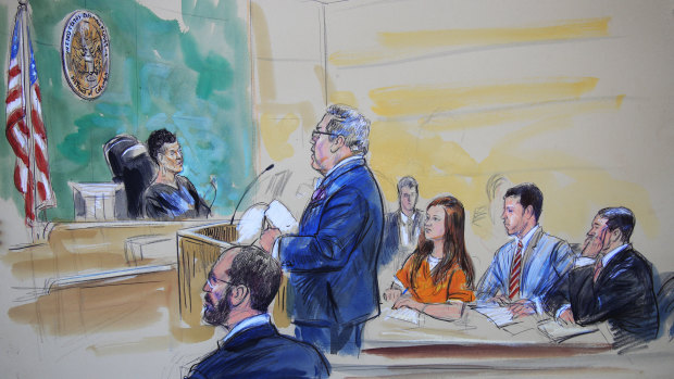 This courtroom sketch depicts Maria Butina, in orange suit, a 29-year-old gun-rights activist suspected of being a covert Russian agent, listening to her lawyer Robert Driscoll, standing, as he speaks to Judge Deborah Robinson during a hearing in federal court in Washington on Wednesday.