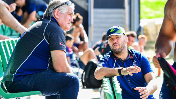 Scott Johnson (left) and Michael Cheika chat during a Wallabies training session in July 2019.