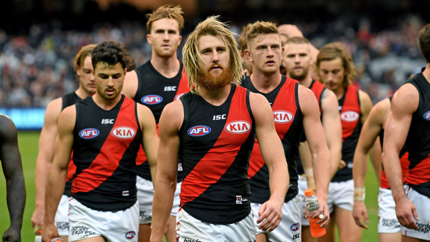Dejected Bombers walk off the ground after the team's loss to Carlton.