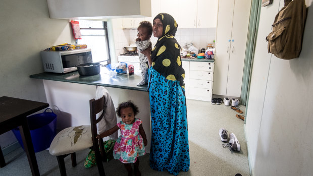 Duretti Garada and two of her children, 18-month-old Haliima and four-month-old Yaaquub, in their apartment, which is next to construction works.