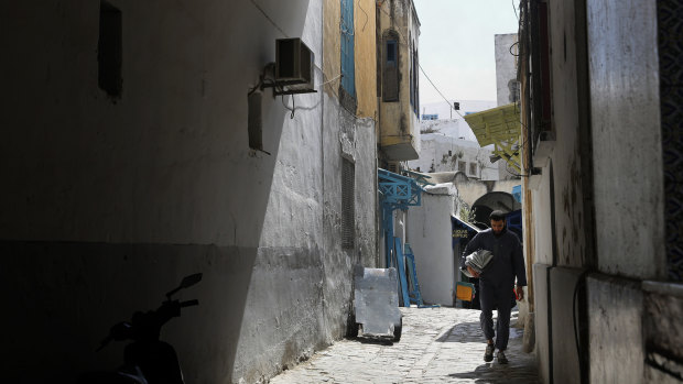 A man walks in an old alley, in the old city of Tunis, Tunisia.