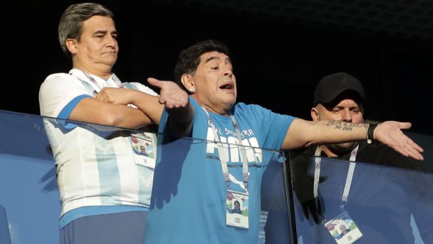 Argentine legend Diego Maradona waves to fans ahead of the match.