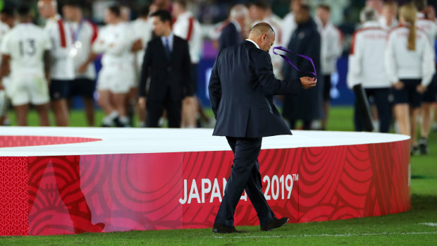 Bitter end: Eddie Jones removes his runners-up medal as he walks away from the podium dejected. A number of England players did likewise.