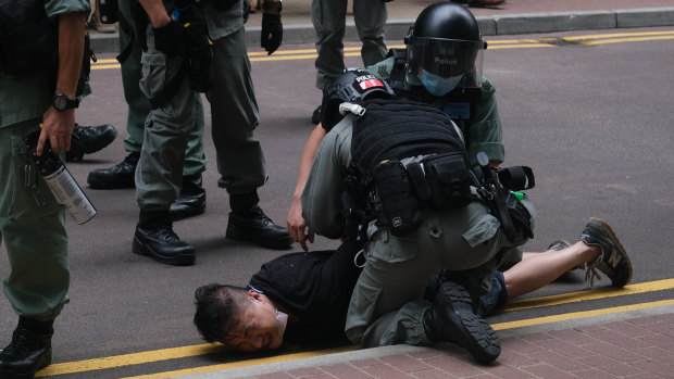 A demonstrator is arrested by riot police during a protest in Hong Kong on Wednesday. China described Hong Kong's new security law as a "sword of Damocles" hanging over its most strident critics