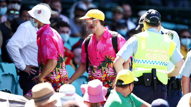 Police deal with spectators at the SCG during a controversial Test against India.