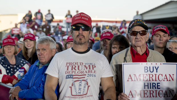A member of the audience wears a shirt that reads "Proud to Be A Trump Deplorable" as President Donald Trump speaks at a rally at Southern Illinois Airport in Murphysboro, Illinois.