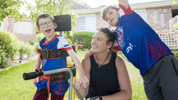 Seven-year-old Lucas Wallace, left, who is affected by cerebral palsy will participate in the Sanitarium Weet-Bix Kids TRYathlon in February. By his side is mum Phyllis Wallace and nine-year-old brother Blake. 