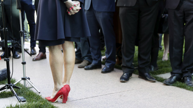 The contrast of Julie Bishop's red shoes against a sea of black footwear spoke to the Liberal Party's issues with female representation. 