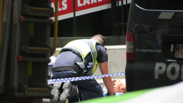 A police officer talks with Gargasoulas after the rampage.