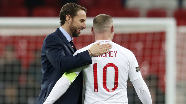 England manager Gareth Southgate shares a moment with Rooney after the game.