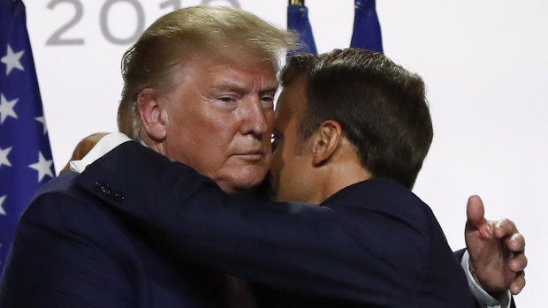 U.S President Donald Trump and French President Emmanuel Macron hug after their joint press conference at the G7 summit.