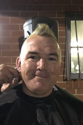 Owen Finegan getting his head shaved.