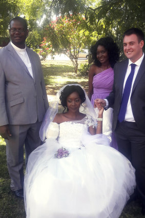 Zanele Ndlovu and Jamie Fox hold hands on their wedding day at a hospital Chapel in Bulawayo, Zimbabwe.