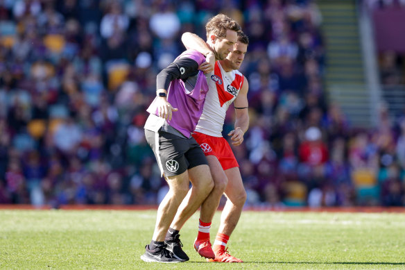 Tom Papley is helped from the Gabba after suffering an ankle injury last Sunday.