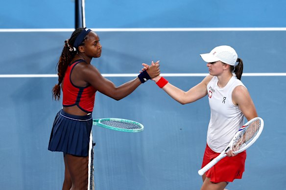 Coco Gauff and Iga Swiatek shake hands after Gauff gets the win for team USA.