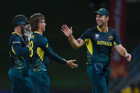 Adam Zampa celebrates a wicket with Matthew Wade, left, and Mitchell Marsh, right.