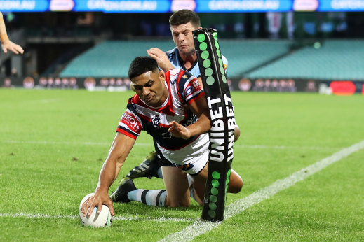 Daniel Tupou beats the tackle of Chad Townsend to score for the Roosters.