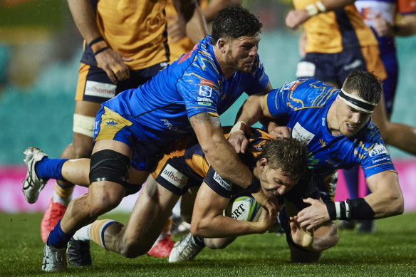 Brumbies back Bayley Kuenzle is tackled in a match against the Western Force last year. 