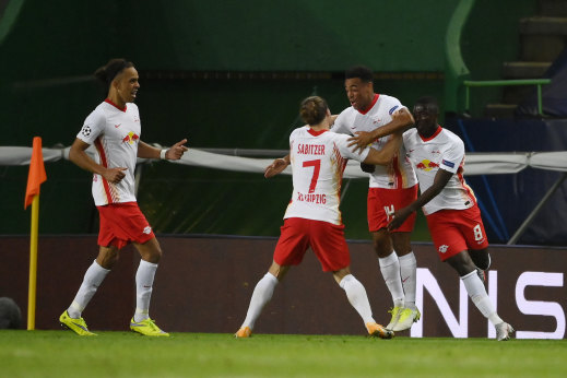 Leipzig's Tyler Adams celebrates with teammates after his late deflected goal booked the German club a first Champions League semi-final berth.