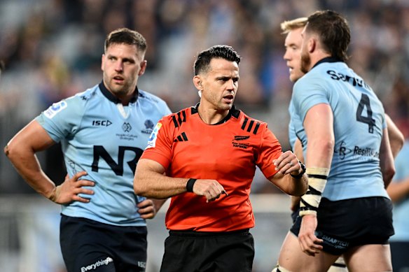 Referee Nic Berry speaks to the referee
