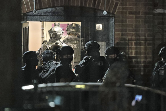 Armed police officers investigate at a block of flats off the Basingstoke Road in Reading after an incident at Forbury Gardens park in the town centre of Reading, England.