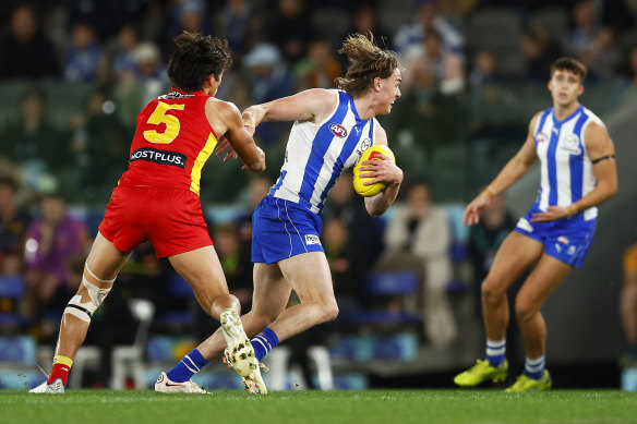 First-gamer Josh Goater attempts to break the tackle of Alex Davies.
