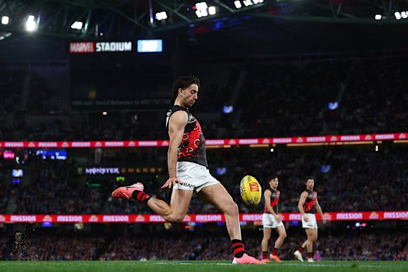 Nic Martin of the Bombers kicks the ball .